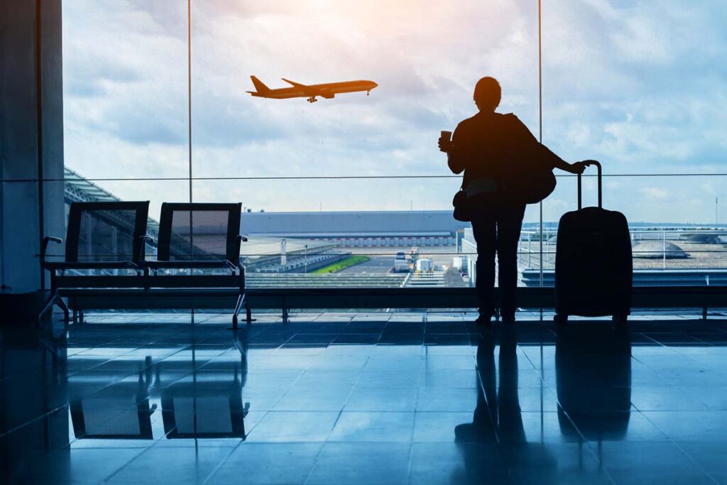 A woman at an airport for a corporate travel trip